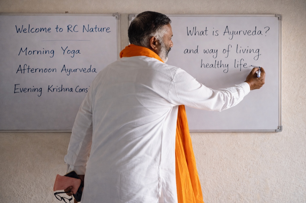 Man teaching Ayurveda concepts on a whiteboard