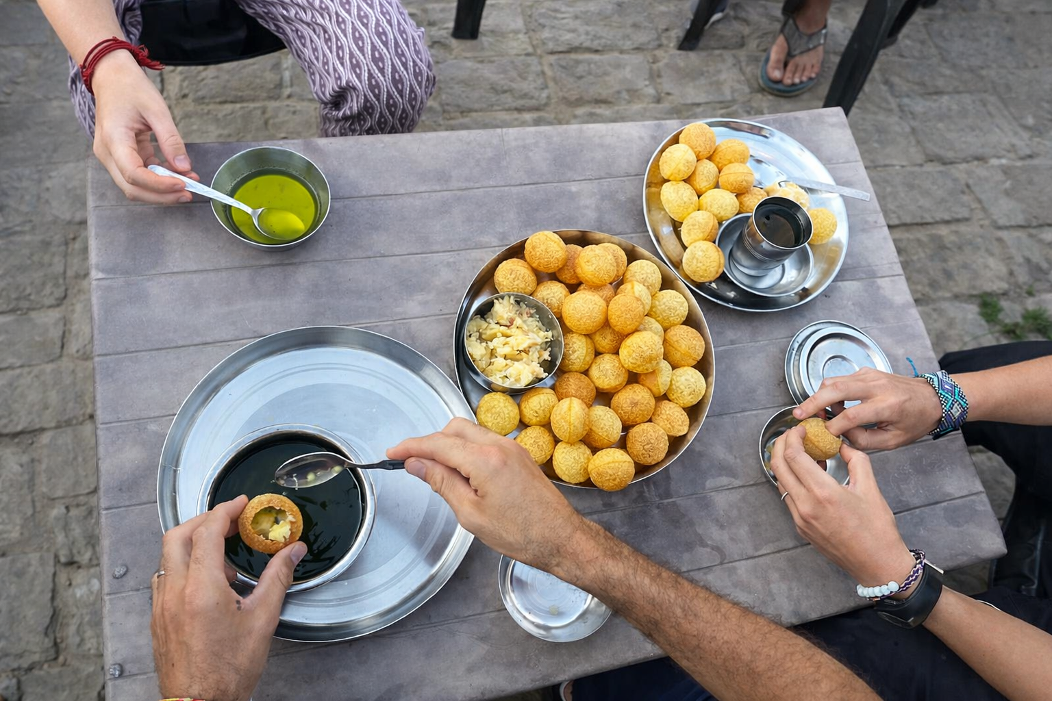 Group of friends eating fruit picnic style on the ground