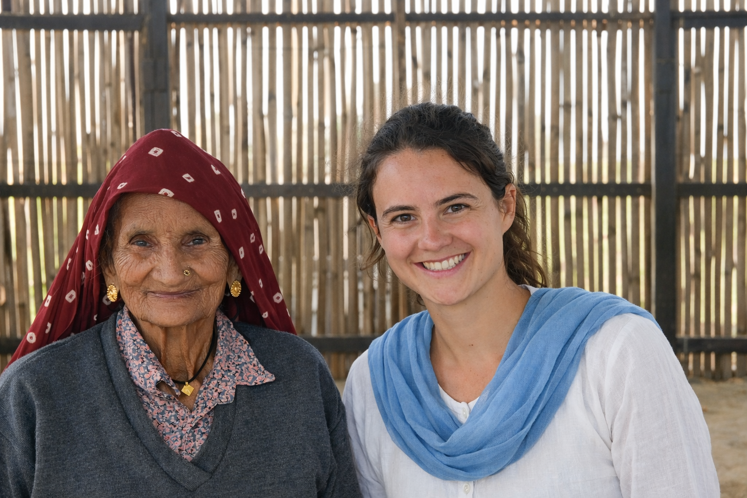 Older and younger woman smiling together