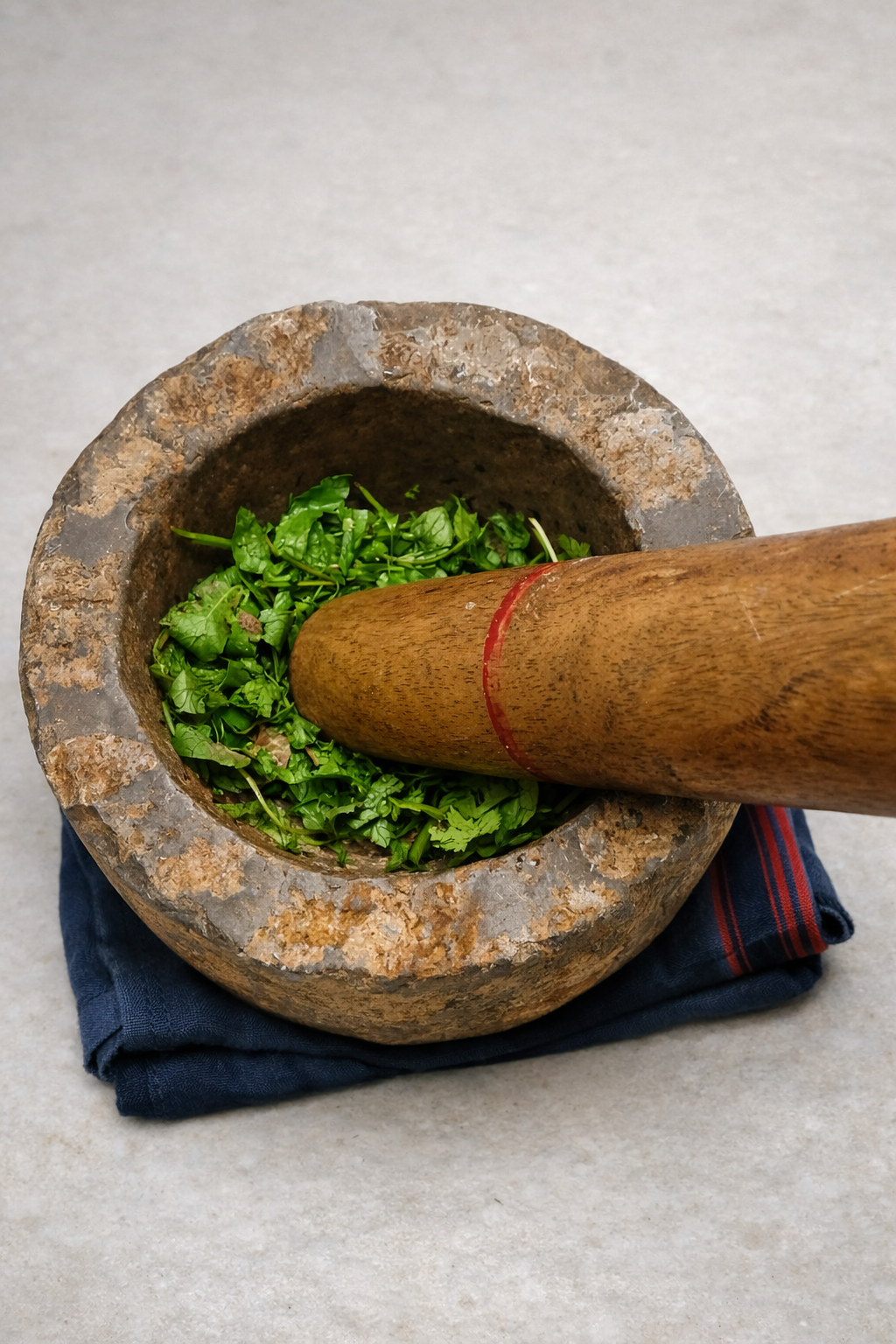 Stone mortar and pestle with fresh green chutney