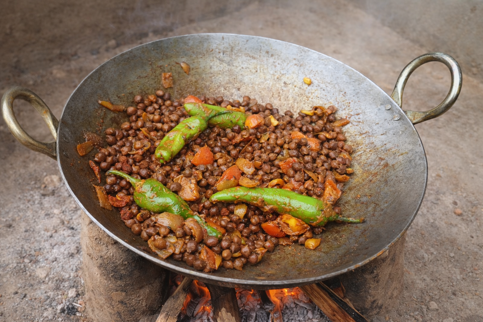 Spicy dish cooking in a large iron wok