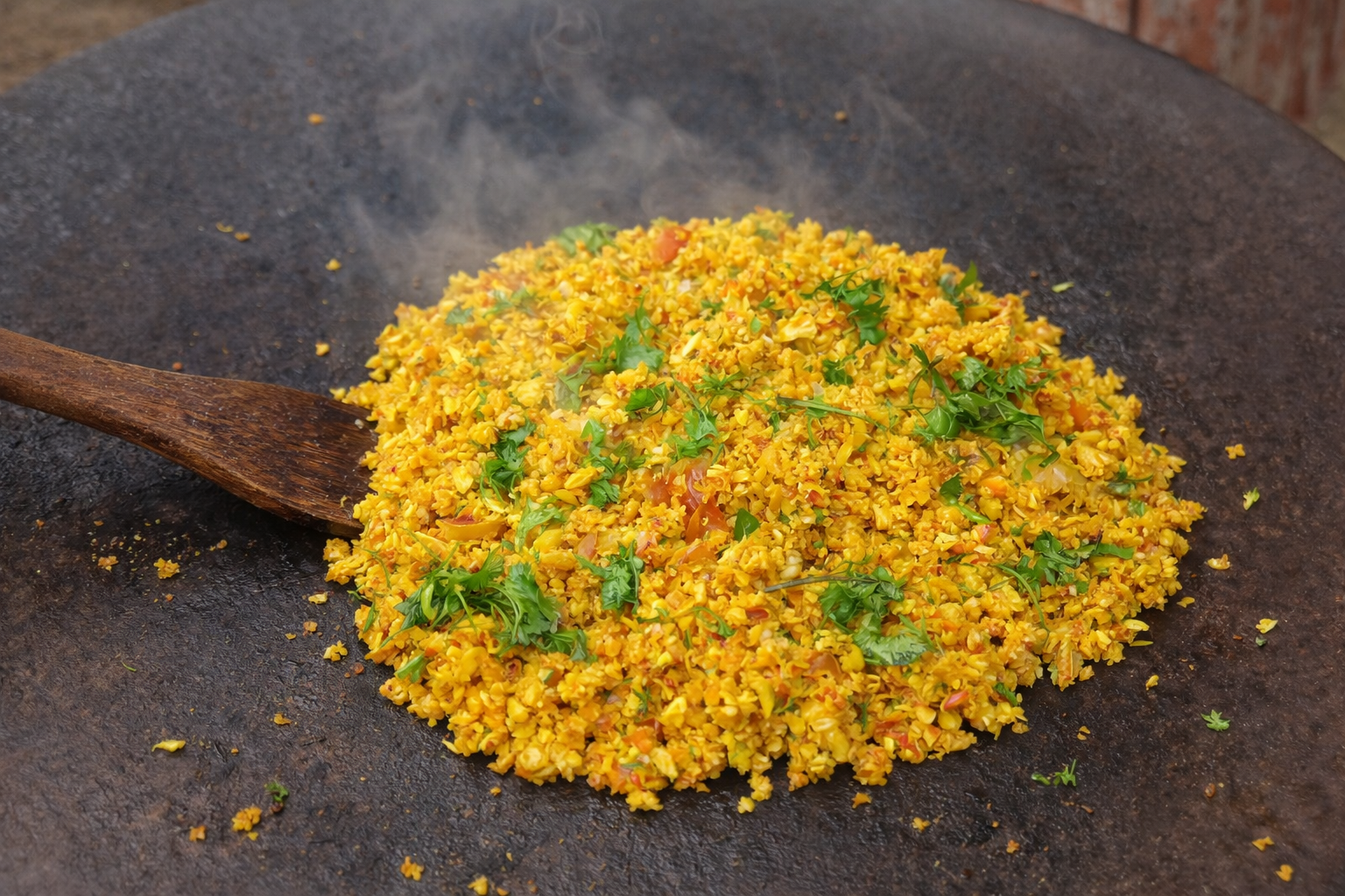 Yellow rice dish (poha or pulao) cooking