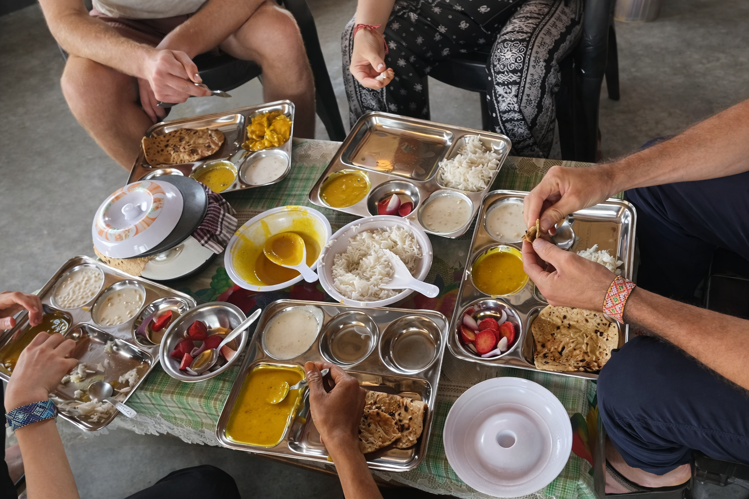 Group of people eating a meal together from above