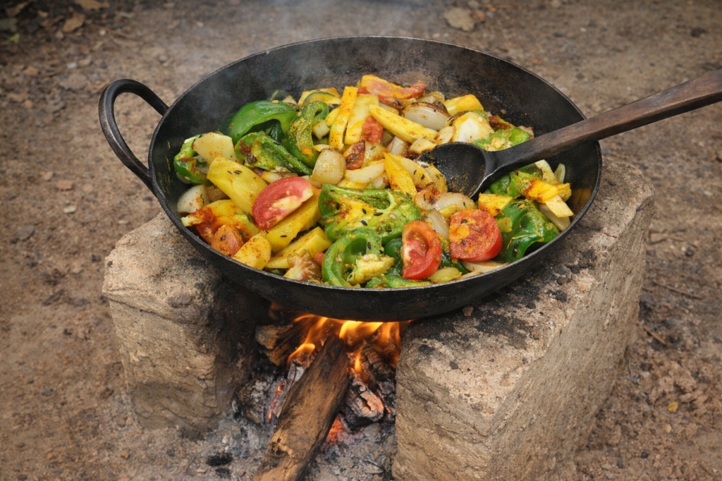 Cooking fresh vegetables in a large outdoor cauldron